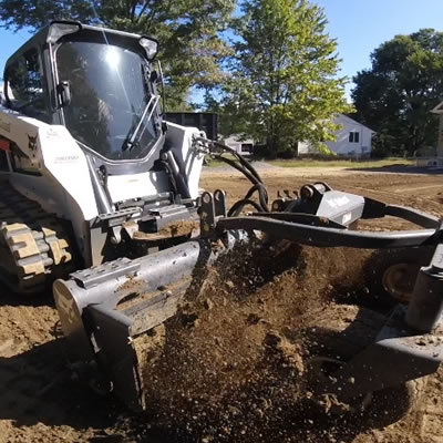 Professional Bobcat services by JWS Land LLC for all your hardscaping needs. Efficient land clearing, grading, and excavation.